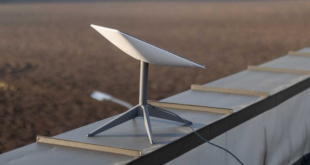 A Starlink satellite dish installed in the Saudi desert, representing the advent of satellite internet services in the region.