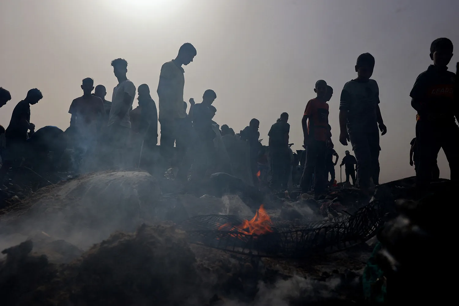 War-torn Gaza skyline under smoke with Israeli military presence—symbolizes the 2024 conflict.